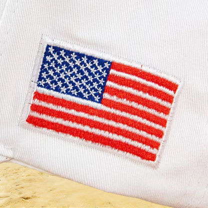 A fashionable white American hat with "45-47" details, perfect for a beach outing, ideal for a leisurely walk by the seaside or